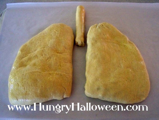 Looking for a gross and creepy appetizer to make? These Lung Calzones are the perfect party food! Filled with delicious madeira mushroom you wont be able to get enough!