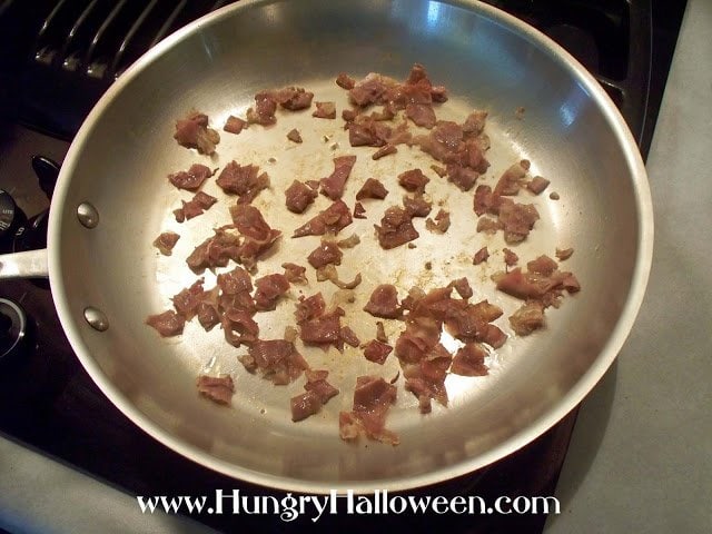 cooking diced Pancetta in a skillet.