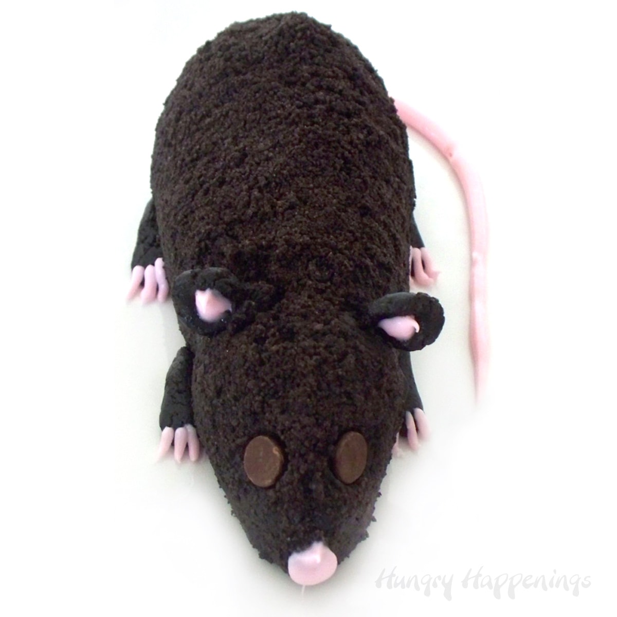 Chocolate cheese ball rat covered in crushed OREO Cookies and decorated with pink cream cheese frosting.