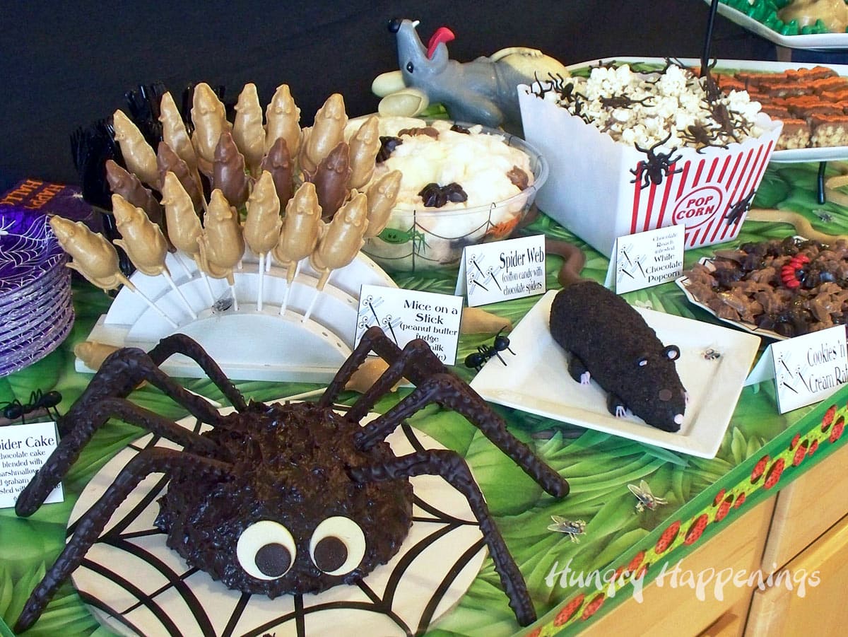 Gross Halloween desserts including a spider cake, cheese ball rat, mouse pops, and chocolate roaches. 