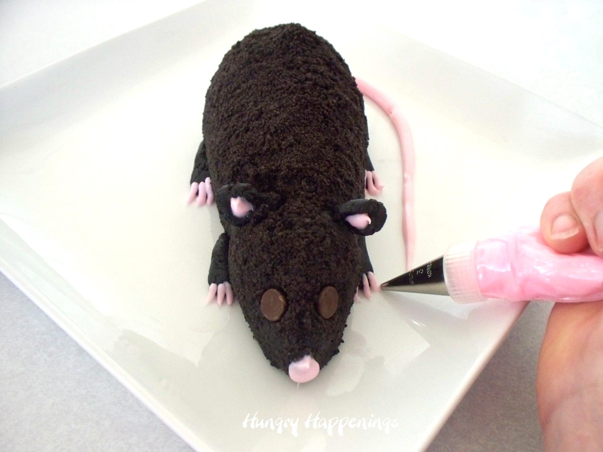 Pipe pink toes onto Oreo Cookie cheese ball rat.