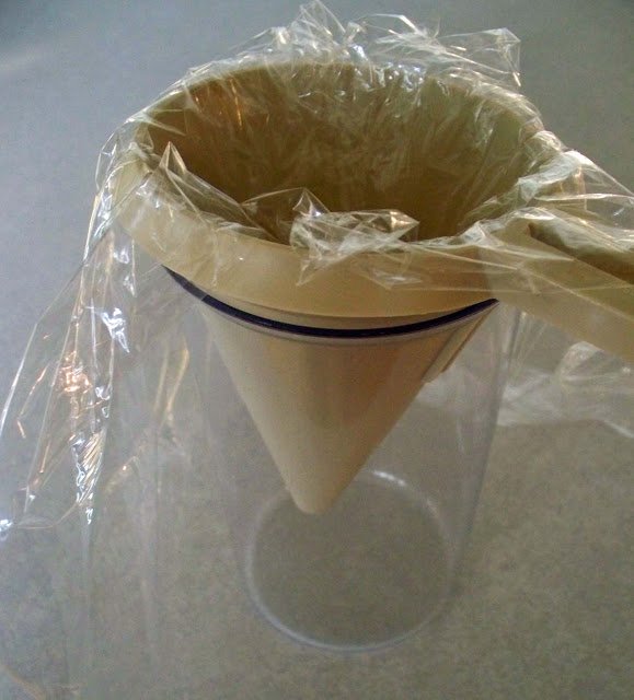 funnel lined with plastic wrap