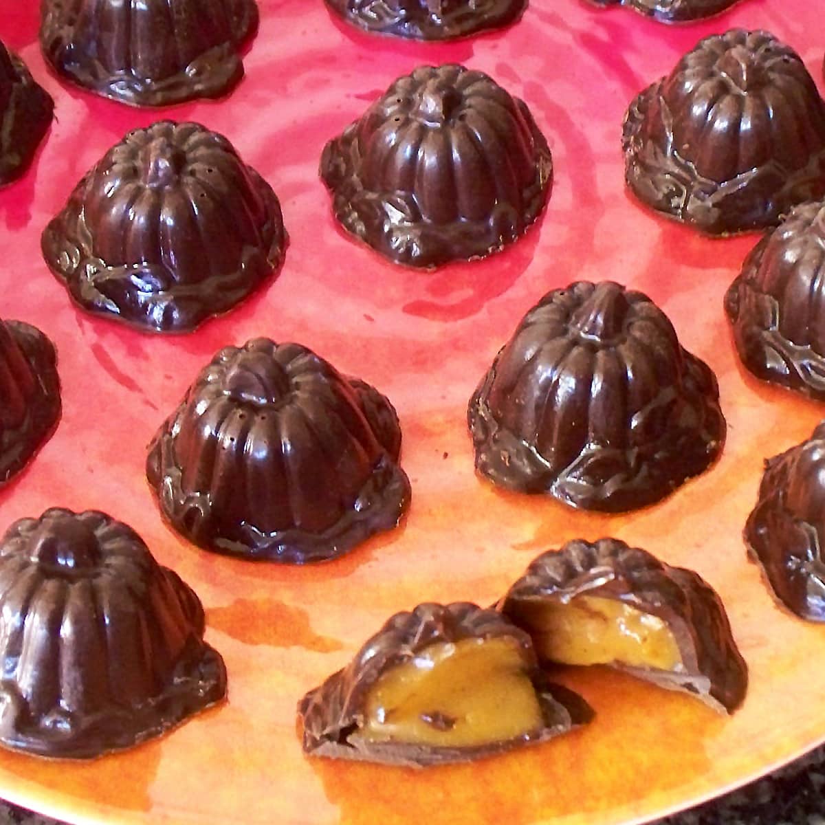 chocolate pumpkin truffles filled with creamy white chocolate pumpkin ganache.