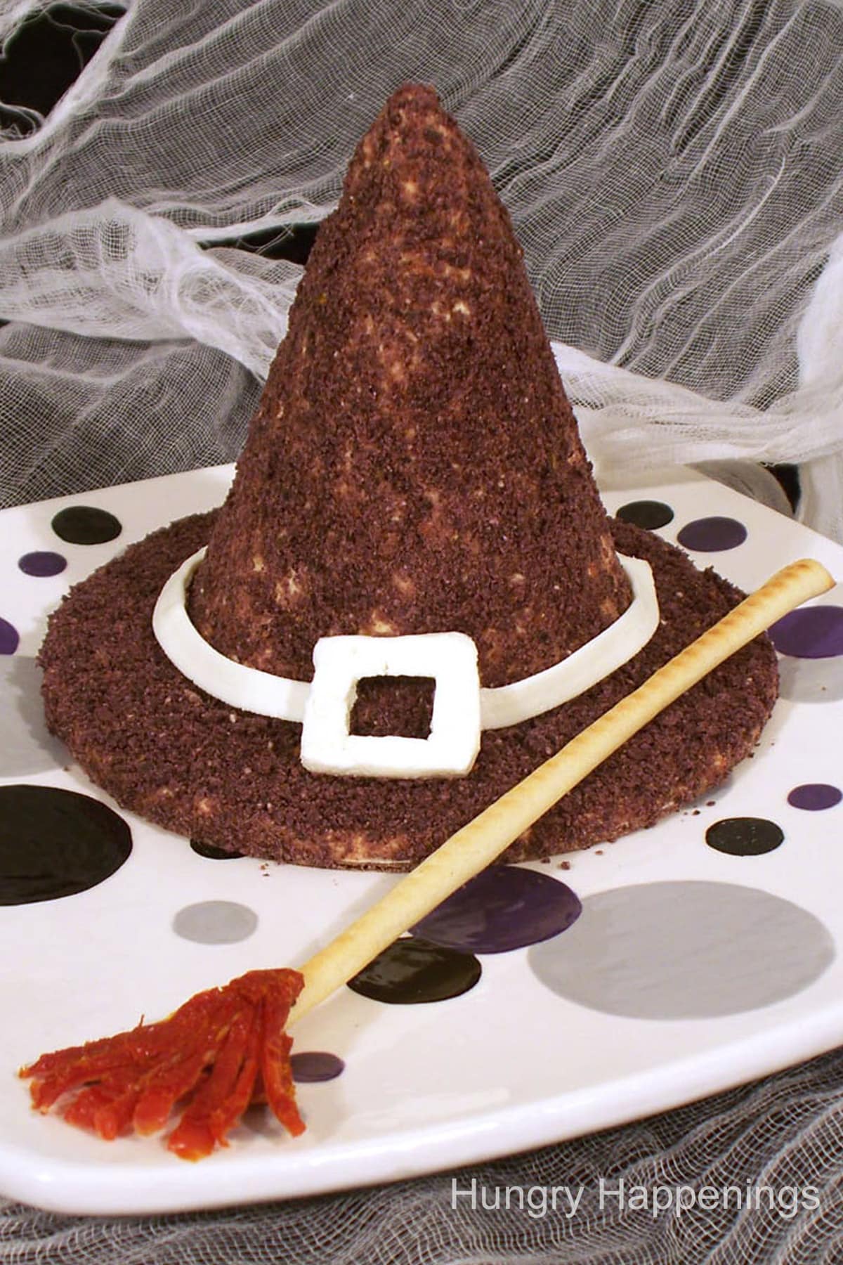 witch hat cheese ball with a breadstick broomstick.