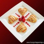 heart-shaped ravioli-style pastries filled with chocolate and served with fresh raspberries