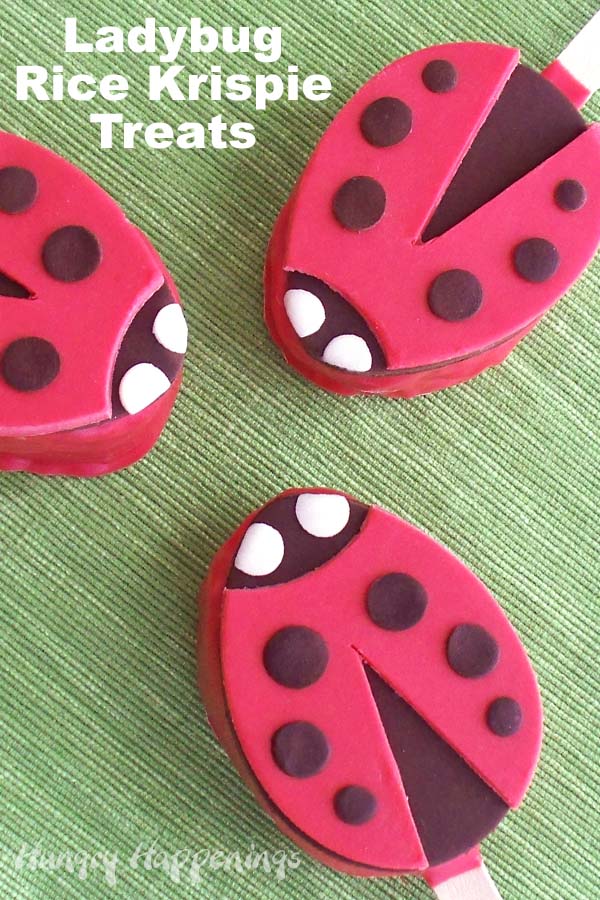 ladybug rice krispie treats topped with red modeling chocolate and black spots.