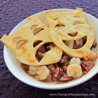 Mardi Gras Gumbo topped with pie crust comedy and drama masks. 