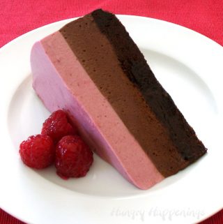 Chocolate Raspberry Mousse Cake with a layer of flourless chocolate cake topped with chocolate mousse and white chocolate raspberry mousse
