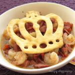 Gumbo with shrimp and sausage is topped with a pie crust crown for Mardi Gras dinner