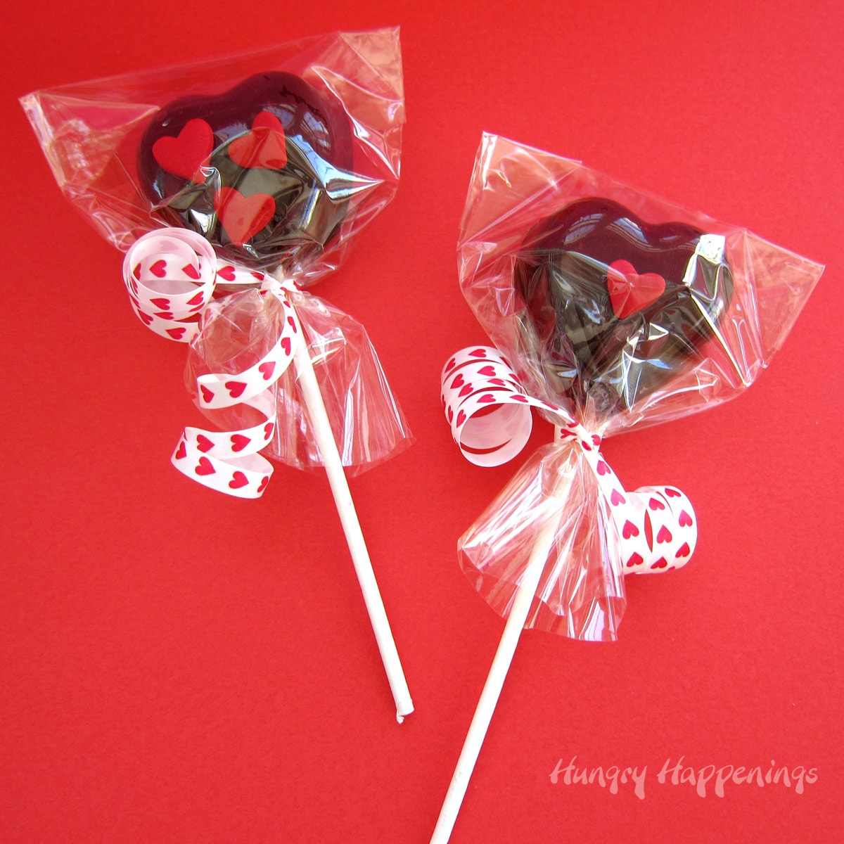 heart-shaped lollipops wrapped in cellophane bags tied with Valentine's Day ribbon