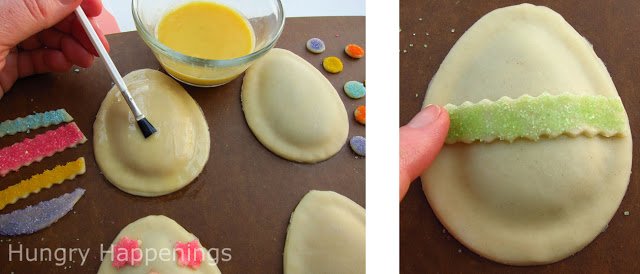 brushing egg wash over an egg-shaped pie dough pastry and adding a stripe of green sugar-coated pie dough on top. 