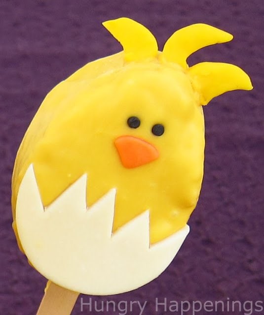 cute hatching chicken Rice Krispie Treat with feathers sticking up out of its head. 