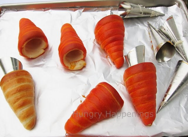 Remove crescent roll carrots from cream horn forms while they are still hot.