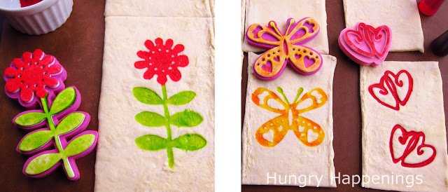puff pastry stamped with a pink flower with green petals, a yellow and orange butterfly, and red hearts. 