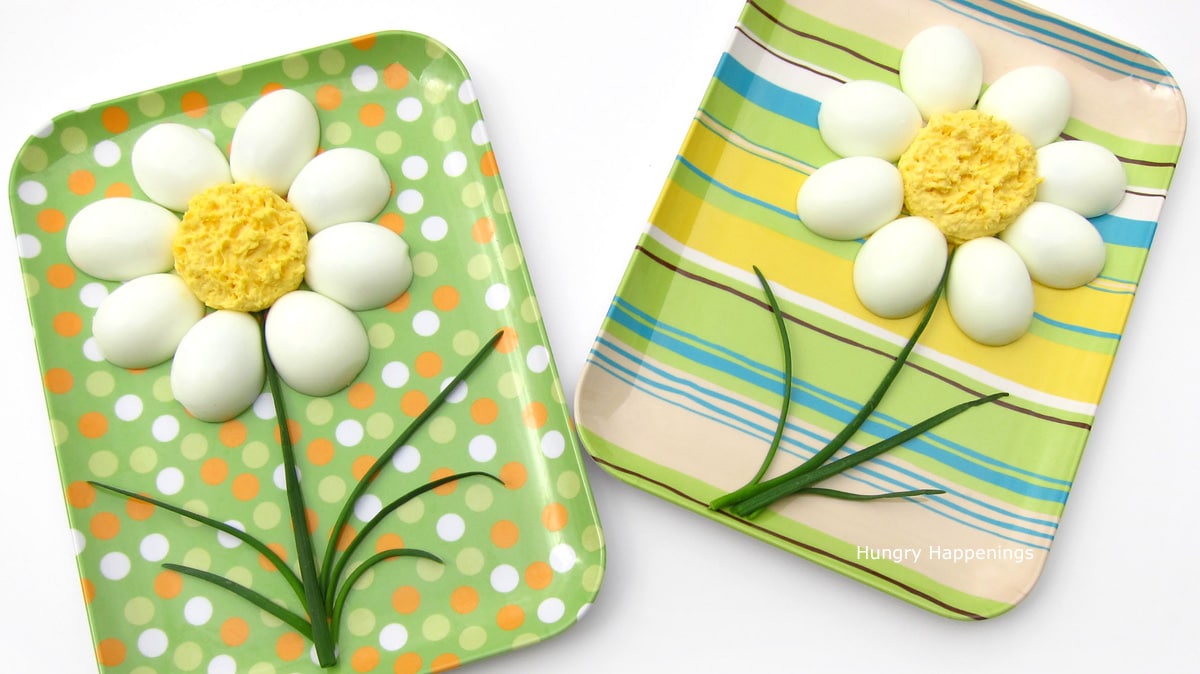 two deviled egg daisies on fun serving platters. 