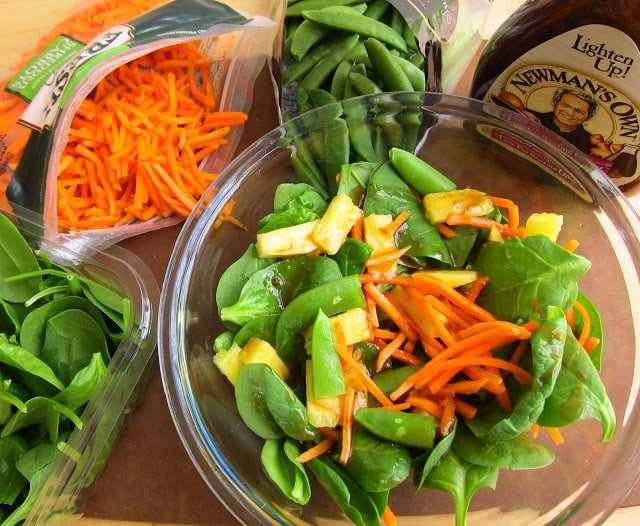 tossing spinach salad with sesame ginger dressing. 