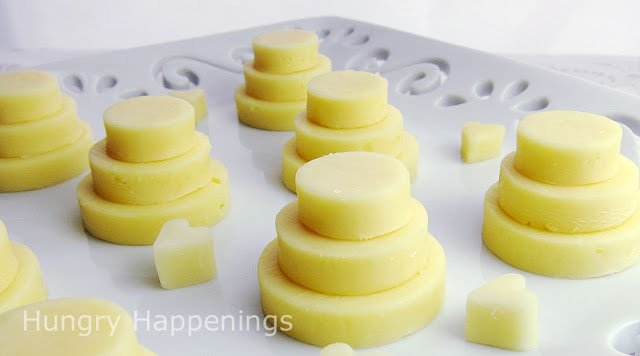 round pieces of cheese staked up to create little wedding cake appetizers. 