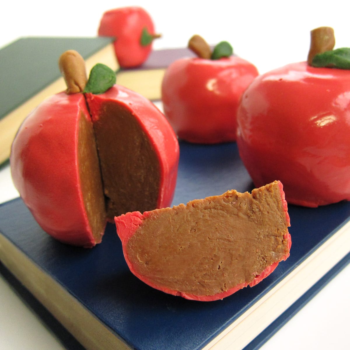 inside-out caramel apples made with chocolate caramel fudge dipped in red candy melts.