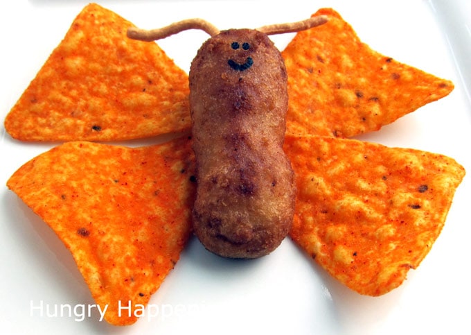 Chicken tenders, nacho cheese corn chips, and chow mein noodles create a cute butterfly for a bug-themed party.