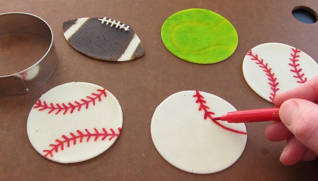 making sports ball-shaped cheese slices using food coloring markers. 