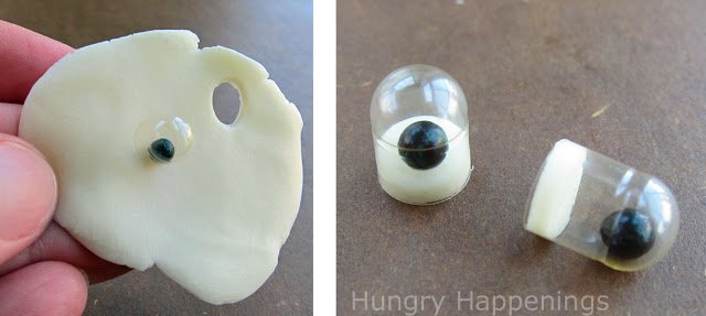 making edible googly eyes with a white modeling chocolate plug on the open end of the gel cap.