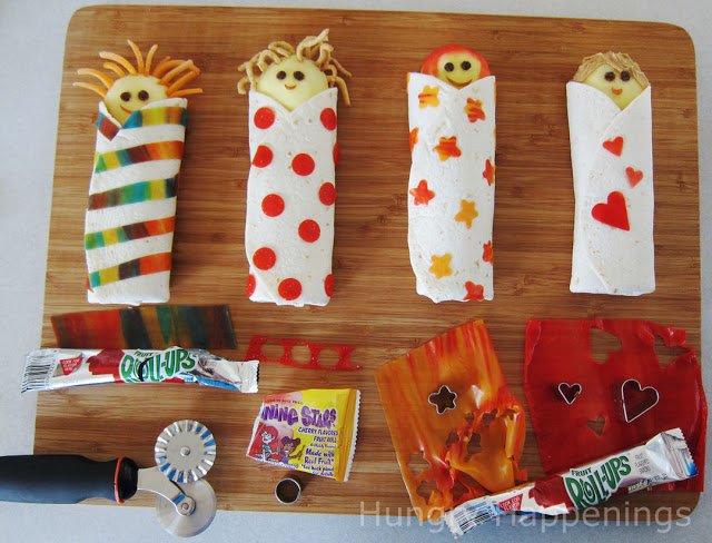 Decorating slumber party snacks with fruit rolls.