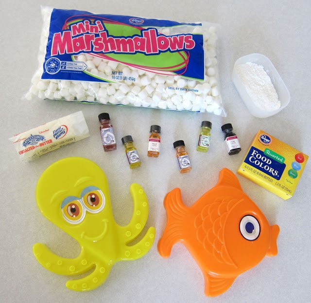 ingredients and supplies to make marshmallow animals including marshmallows, butter, powdered sugar and cornstarch, candy oils, food coloring, and sand molds. 
