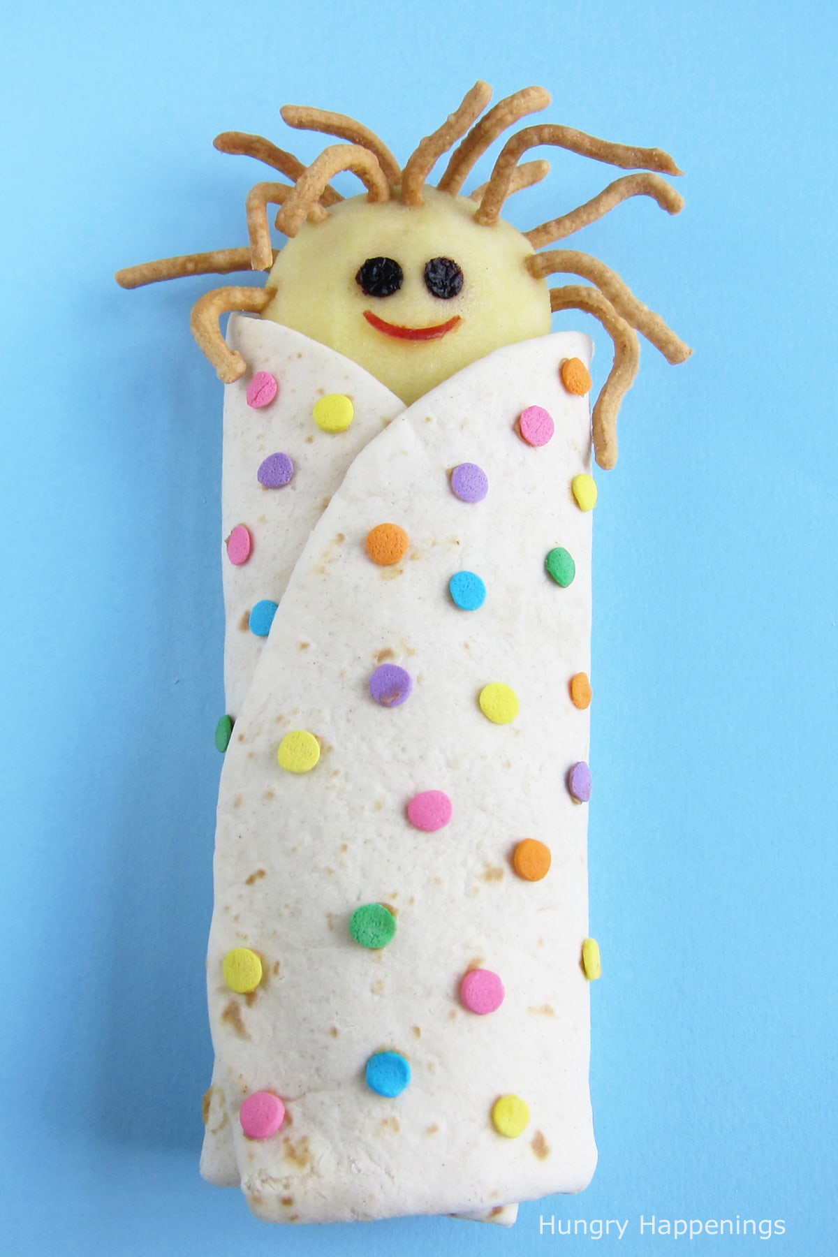 peanut butter and apple wrap decorated like a sleeping bag with an apple kid inside. 