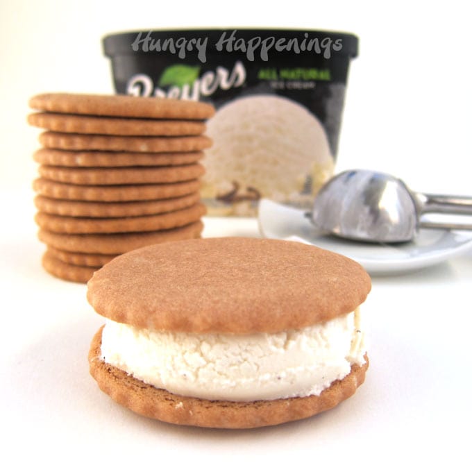 root beer cookies stacked up behind a root beer floatwich and in front of a carton of vanilla ice cream