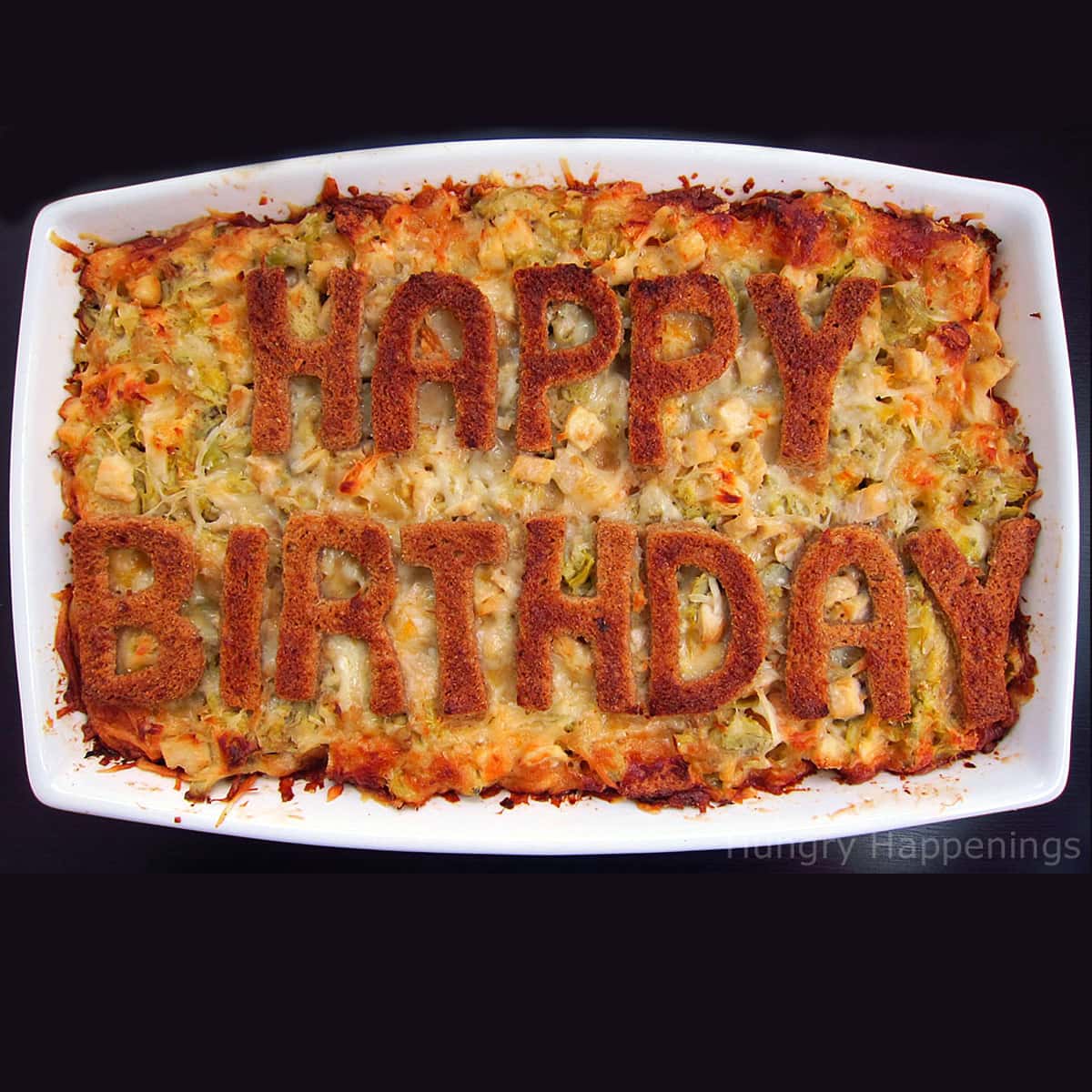 Chicken and artichoke bread pudding decorated with "Happy Birthday" toast on top