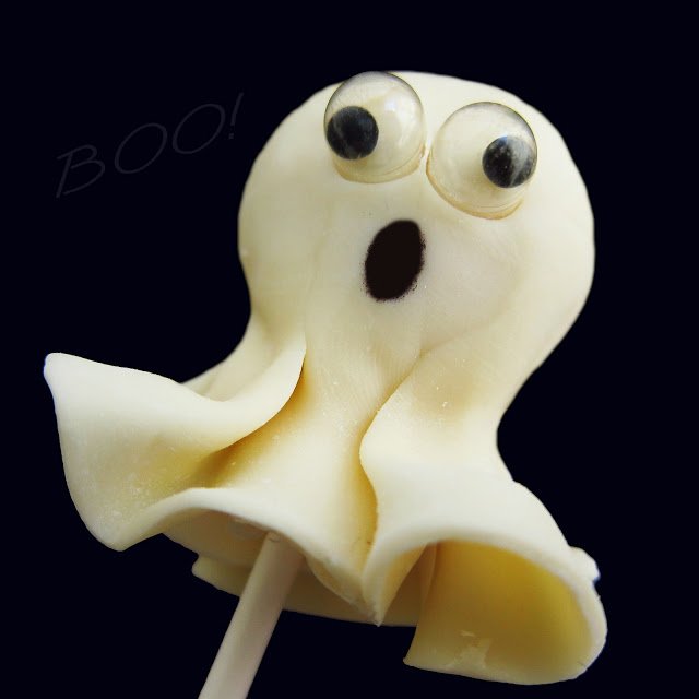 white chocolate rice krispie treat ghost lollipop with edible googly eyes that actually wiggle.