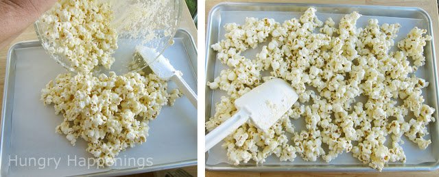 spread white chocolate popcorn onto a parchment paper-lined cookie sheet