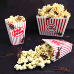 gross Halloween popcorn - buckets of white chocolate popcorn filled with chocolate roaches