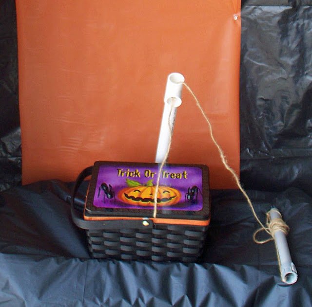 a Halloween picnic basket with the lid attached to a rope.
