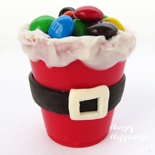 red-colored white chocolate Santa suit candy cup.