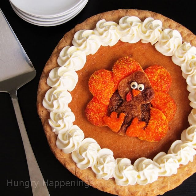 pumpkin pie decorated with whipped cream and a cute pie crust Turkey decorated with brown sugar, orange sugar, and candy eyes. 