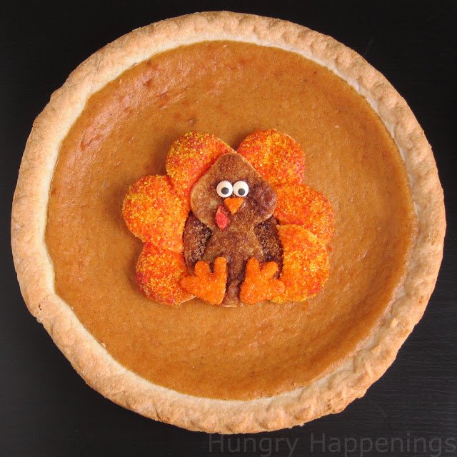 pumpkin pie topped with a cute Thanksgiving decoration 