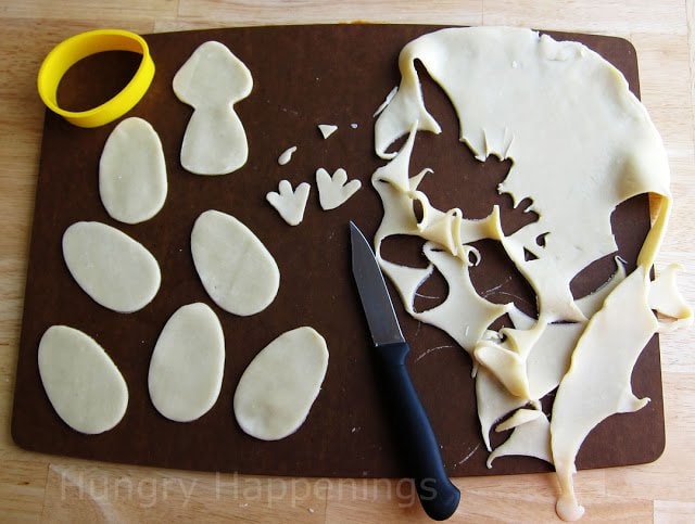 cutting turkey decorations out of pie dough. 