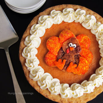 Thanksgiving pie decorated with a pie crust turkey on top of a pumpkin pie.