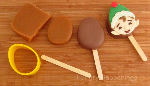 milk chocolate-dipped caramel lollipop topped with a modeling chocolate elf decoration. 