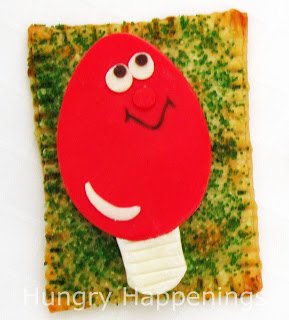 Pop tart decorated with a red Christmas light.