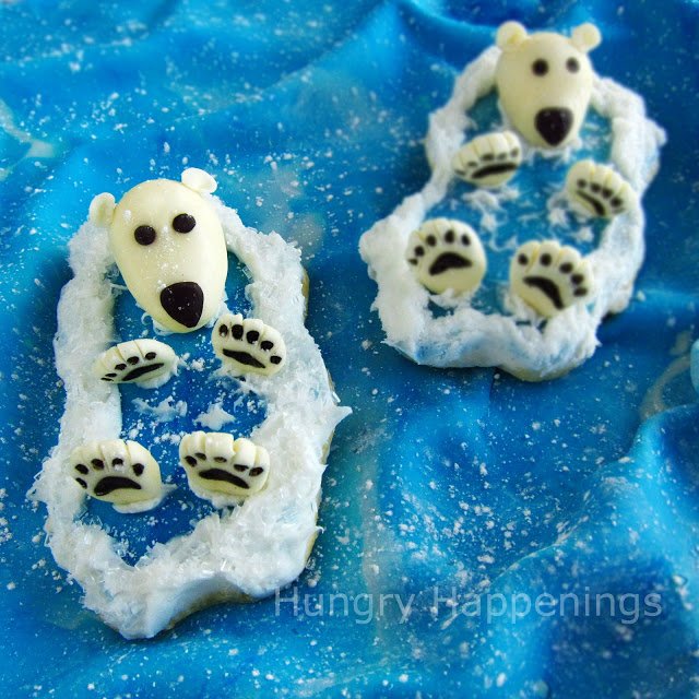 cute polar bear cookies displayed on a piece of modeling chocolate that looks like the ocean.