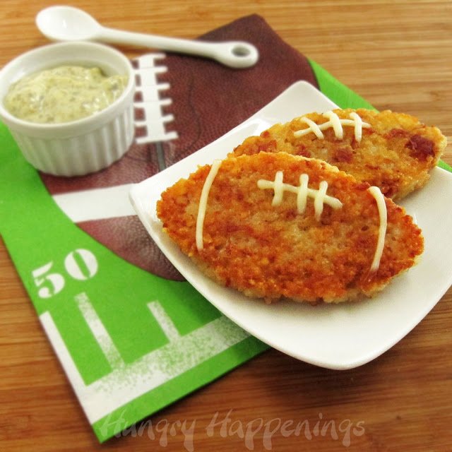 fried rice patties shaped into footballs served on a white plate on a Super Bowl napkin with pesto aioli.
