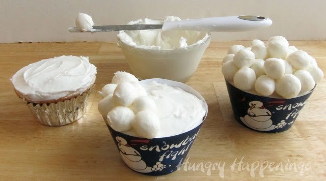 decorating cupcakes with snowballs made with frozen white frosting.