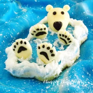 These polar bear cookies are so darn cute. Each has a 3 dimensional polar bear floating on it's back in a cookie ocean with it's big fluffy paws and head sticking up out of the modeling chocolate water.