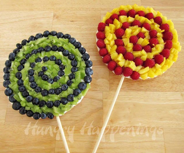fruit pizza lollipops topped with kiwi and blueberries or raspberries and pineapple. 