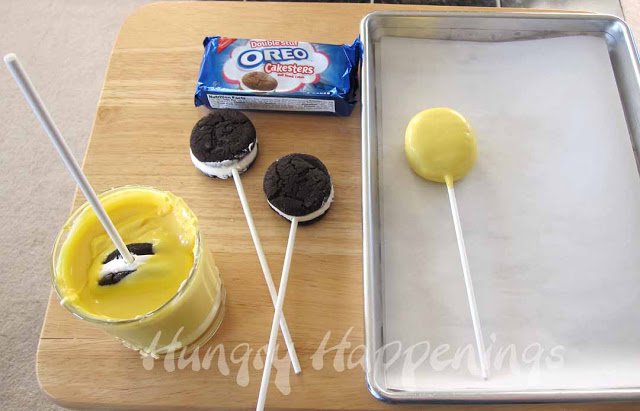 dipping OREO Cakesters in yellow candy melts.