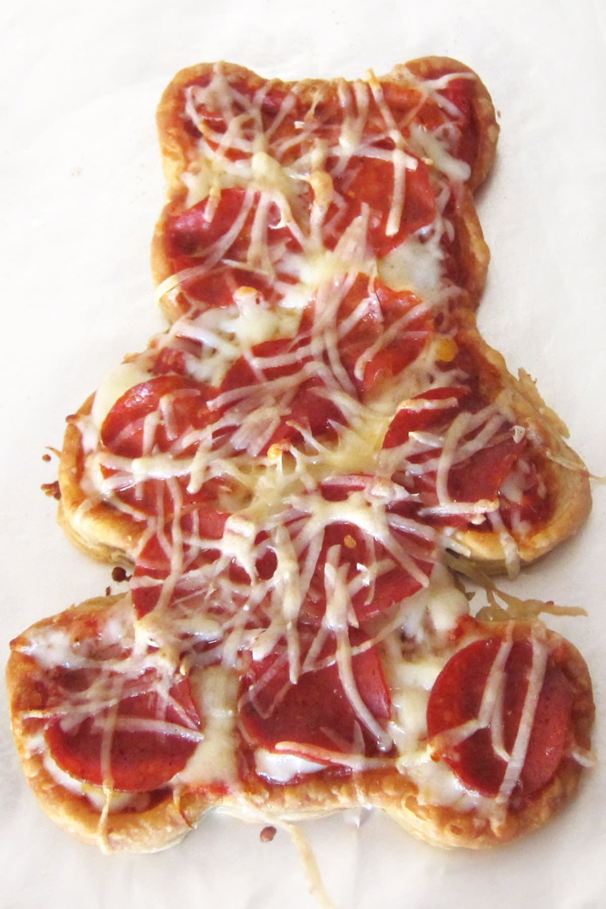 teddy bear pizza topped with pizza sauce, pepperoni, and mozzarella cheese