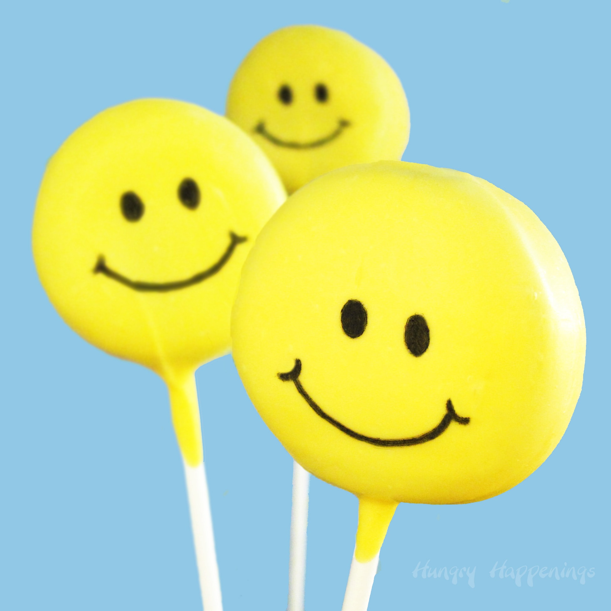 yellow smiley face lollipops made with OREO Cakesters.