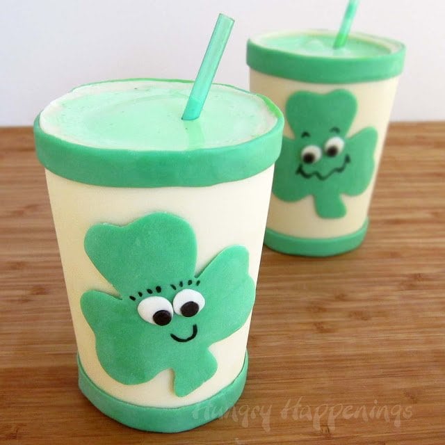 Edible white chocolate cups filled with Shamrock Shakes flavored with mint.